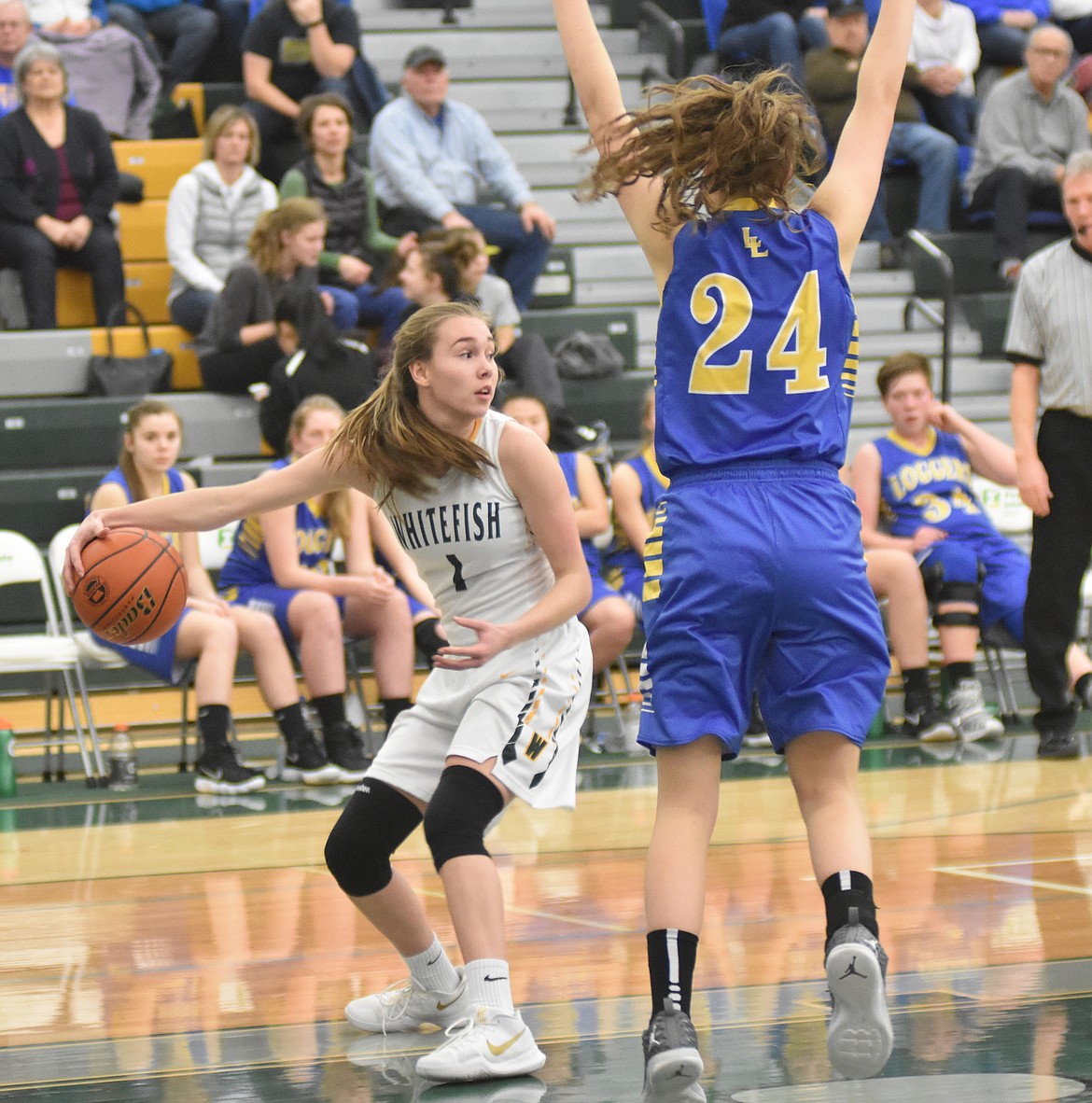 Lady Bulldog Kit Anderson dribbles the ball around Logger Jayden Winslow Friday night at Whitefish High School. (Heidi Desch/Whitefish Pilot)