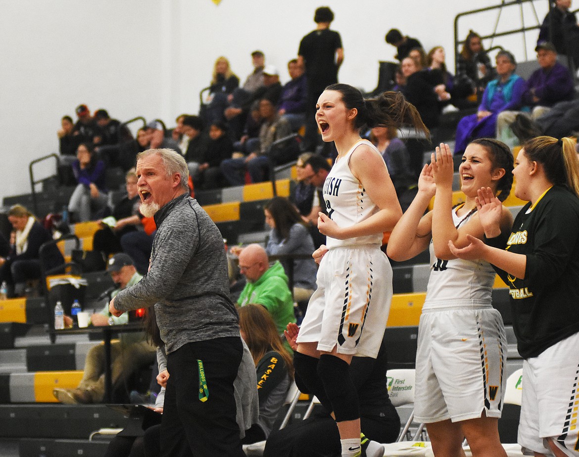 The Lady Bulldogs bench celebrates after a late-game basket Saturday against Polson at home. (Daniel McKay/Whitefish Pilot)