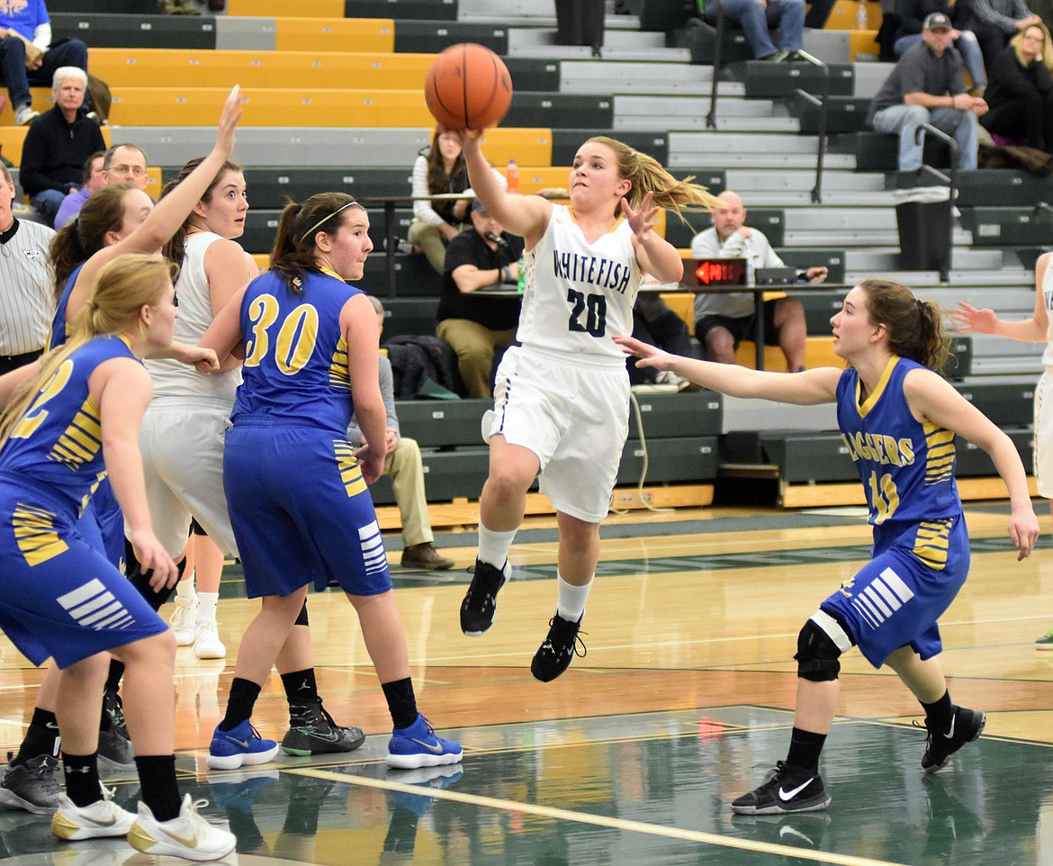 Lady Bulldog Ashton Ramsey goes up for a shot aginst Libby Friday night at Whitefish High School. (Heidi Desch/Whitefish Pilot)