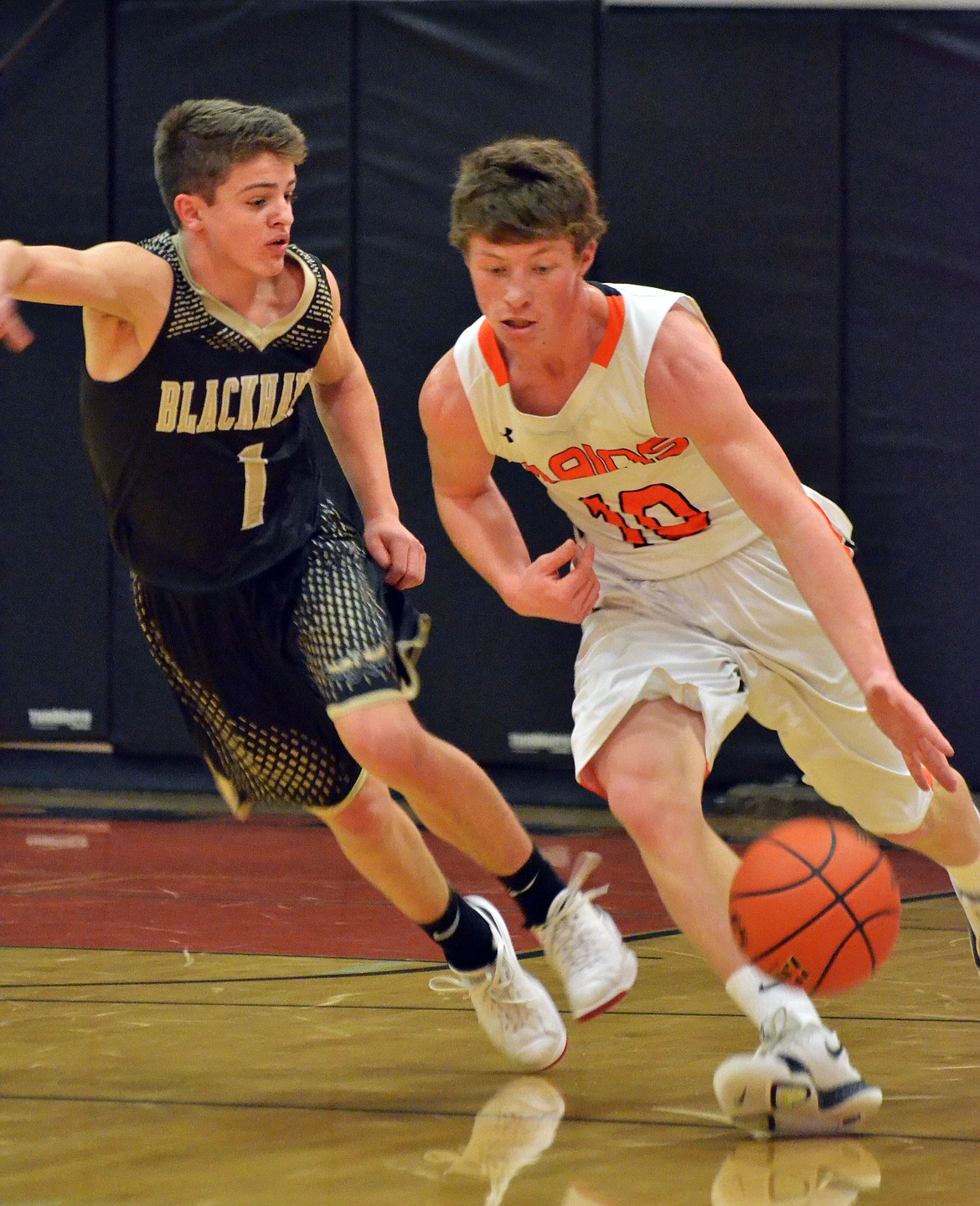 Black Hawk Avery Smith (1) struggles to keep up with Tanner Ovitt (10) as he brings the ball up the court (Erin Jusseaume/ Clark Fork Valley Press)