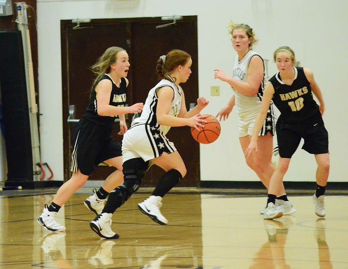 Kassidy Kinzie (10) drives to the hoop against the Seeley-Swan defense. (Erin Jusseaume/ Clark Fork Valley Press)