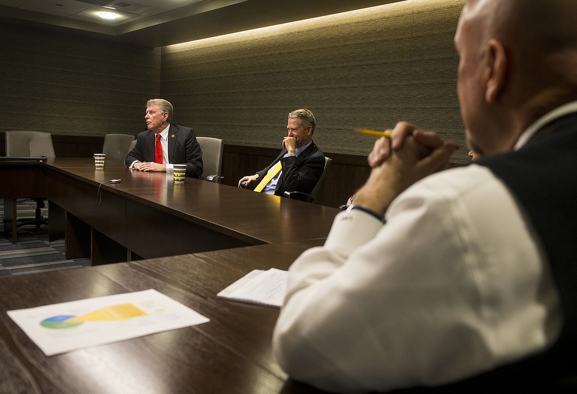 Coeur d&#146;Alene Press Publisher Larry Riley, right, listens in as Idaho Governor Butch Otter, left, speaks about taxes, healthcare and education Monday morning at The Coeur d&#146;Alene Press. (LOREN BENOIT/Press)