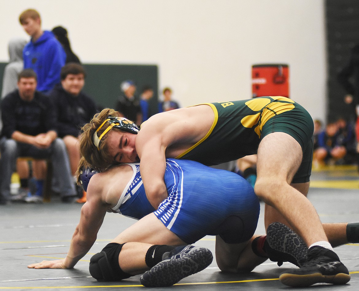 Jack Eisenbarth fights off Wildcat wrestler Nathan Hader during the Whitefish Duals on Friday at Whitefish High School. (Daniel McKay/Whitefish Pilot)