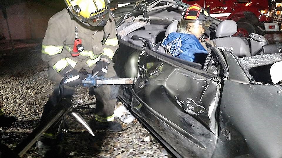 A Superior volunteer firefighter uses equipment to remove a &#147;victim&#148; from a wrecked car. Ideally the task is completed within five minutes. (Photo courtesy Superior Volunteer Fire Station)