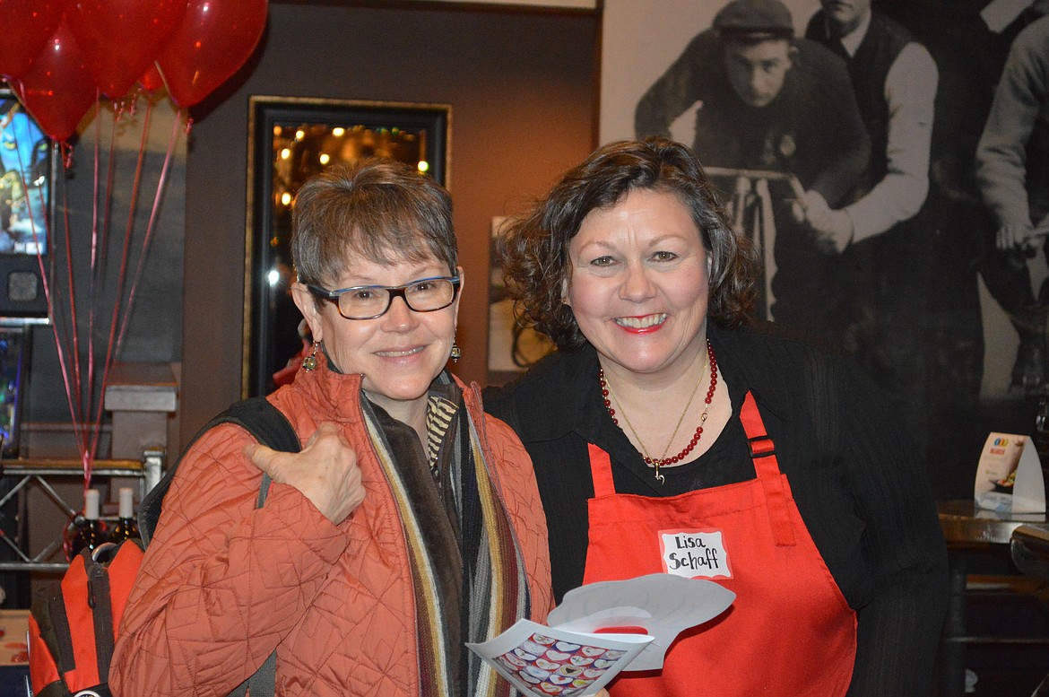 Attendee Suzanne Marshall smiles with silent auction volunteer Lisa Schaff. (Courtesy photo.)
