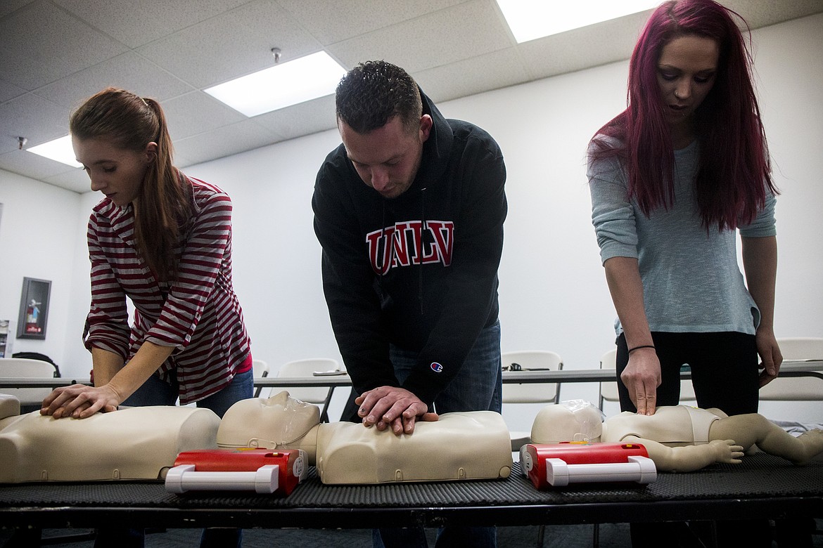 LOREN BENOIT/Press 
From left, Roger&#146;s Ice Cream &amp; Burgers employees Amber McIlreavy, Graham Michels, and Hannah Miars do chest compressions during a CPR training class Thursday afternoon at CPR Central in Coeur d&#146;Alene.