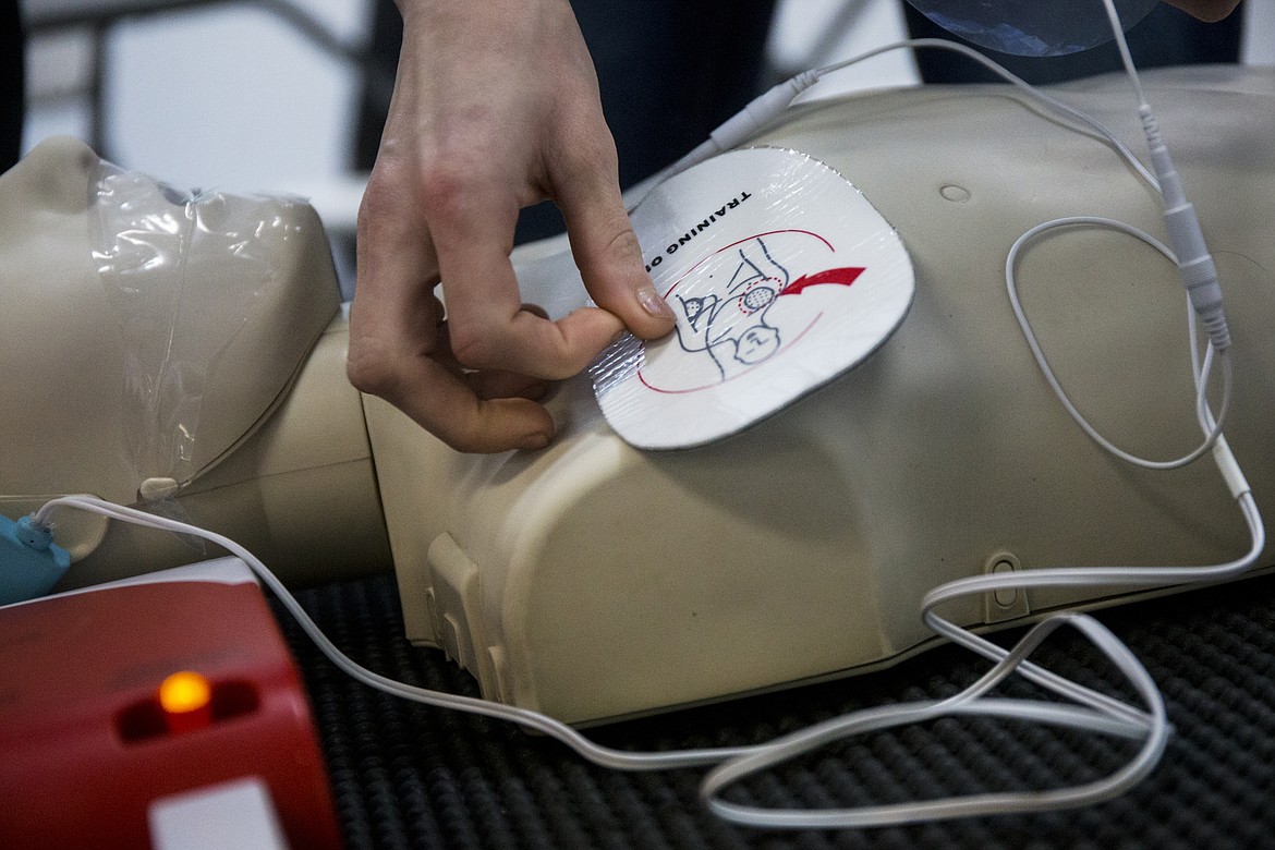 Hannah Miars places a shock pad on a dummy during a CPR training class Thursday afternoon at CPR Central in Coeur d&#146;Alene. (LOREN BENOIT/Press)