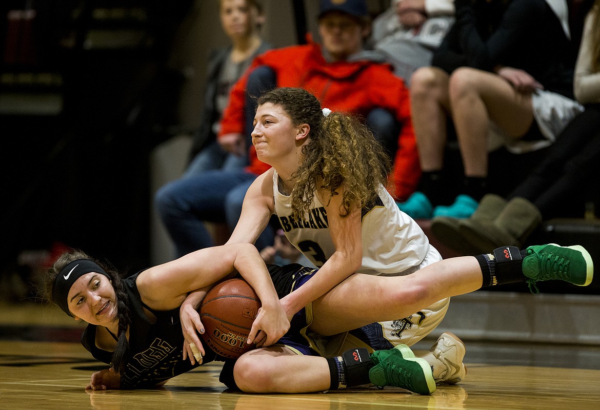 LOREN BENOIT/Press
Lilly Kelley wrestles the ball away from Kellogg's Jaron Figueroa in the 3A District 1 championship game Wednesday night at North Idaho College.