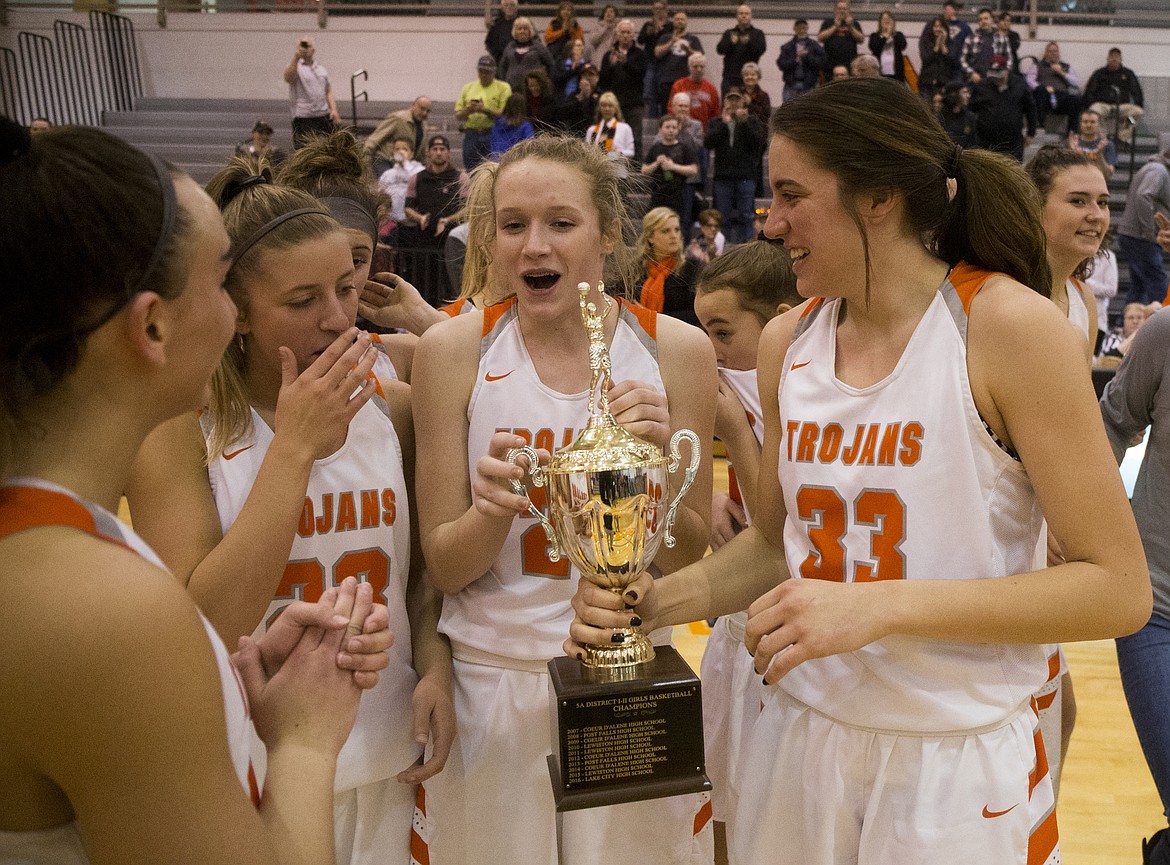 From left, Post Falls players Bayley Brennan, Shaye Schreibeis, Tyler McCliment-Call, and Melody Kempton celebrate their 5A Region 1 Championship win over Lewiston Tuesday night at Post Falls High School. (LOREN BENOIT/Press)