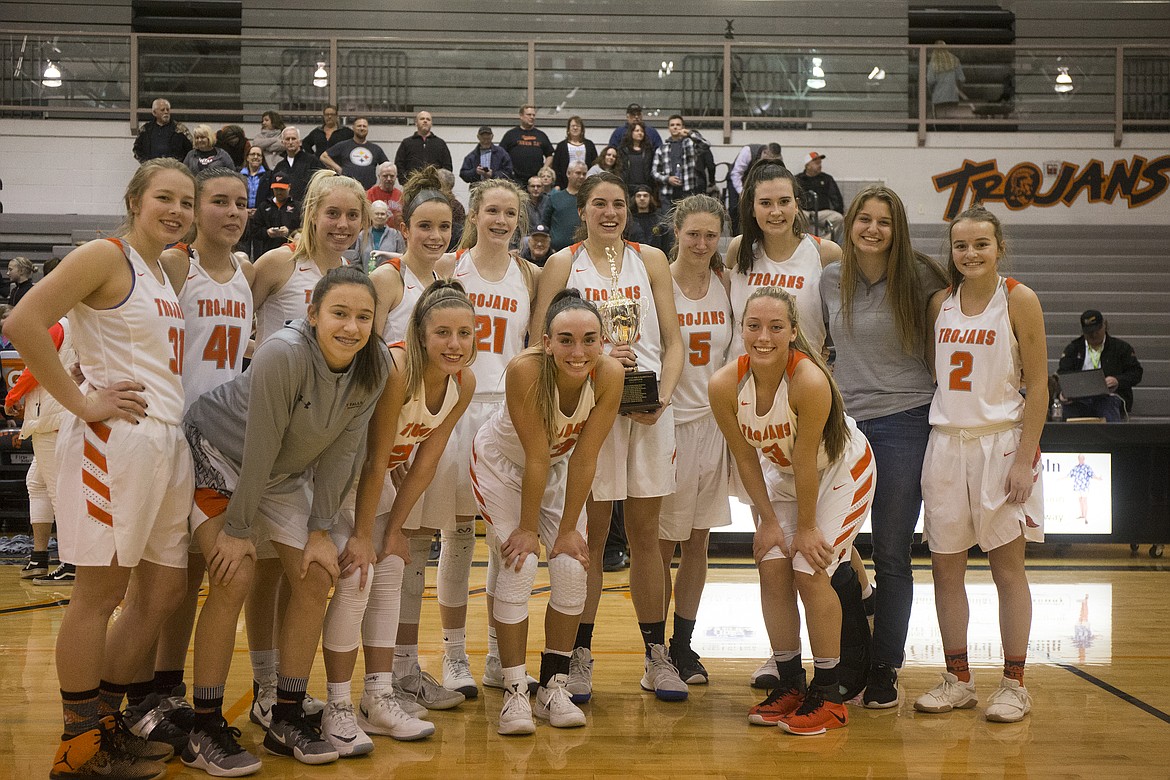 The Post Falls girls basketball team poses for a group photo with their 5A Region 1 Championship trophy. (LOREN BENOIT/Press)