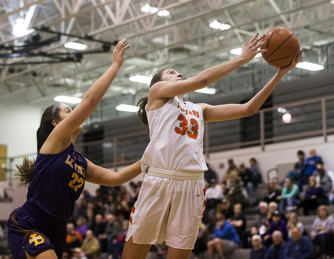 Melody Kempton of Post Falls goes for a layup in front of Lewiston's Madison Stoddard in the 5A Region 1 Championship game. (LOREN BENOIT/Press)