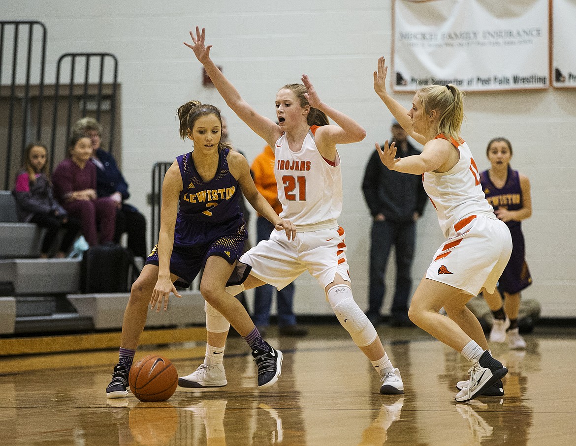 Tyler McCliment-Call (21) and Jenna Gardiner (11) pressure Lewiston's Demi Randall in the 5A Region 1 Championship game Tuesday night at Post Falls High School. (LOREN BENOIT/Press)