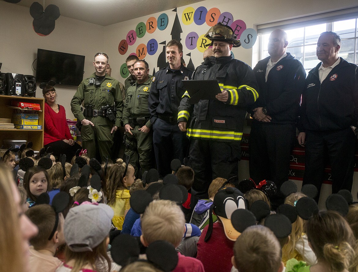 Firefighter Burt Maines reads a Make-A-Wish proclamation to friends and supporters at Landon Hill&#146;s surprise party Tuesday in Coeur d&#146;Alene.