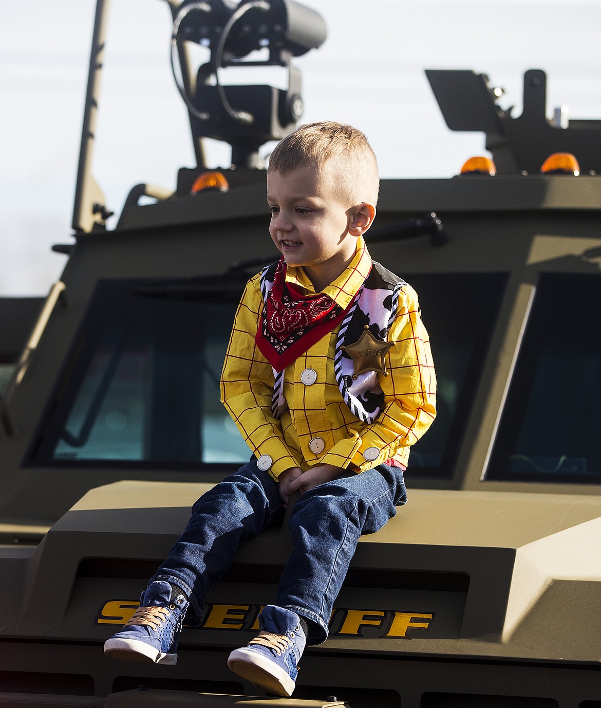 Landon Hill, 4, sits on top of the Sheriff Office's BearCat Tuesday morning at his Make-A-Wish surprise party. (LOREN BENOIT/Press)