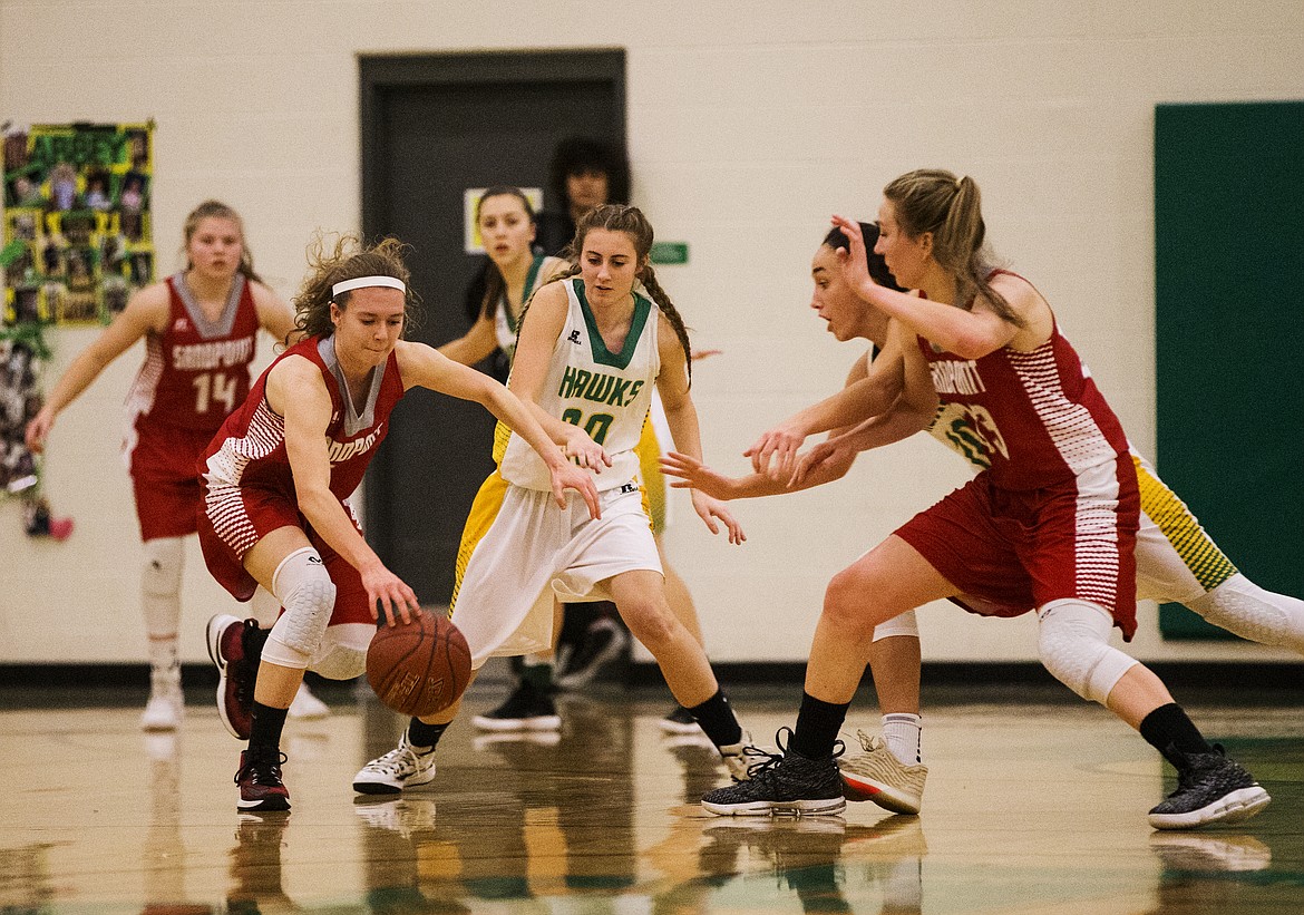 Ciera Bailey of Sandpoint dribbles the ball away from Lakeland defenders Izzy Kirk (30), and Sofi Schnepf.