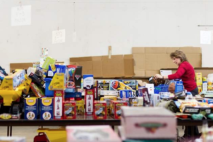 SHAWN GUST/Press File
Tina Batha, president of the Marine Corps League Auxiliary Pappy Boyington Unit, chooses items for a children&#146;s gift bag while volunteering at the Toys for Tots distribution center in Post Falls in this 2012 photo. The ladies of the auxiliary support the Marines in their families by helping with Toys for Tots, fundraisers, Memorial Day gatherings and more. Their auxiliary is the only one in the state.