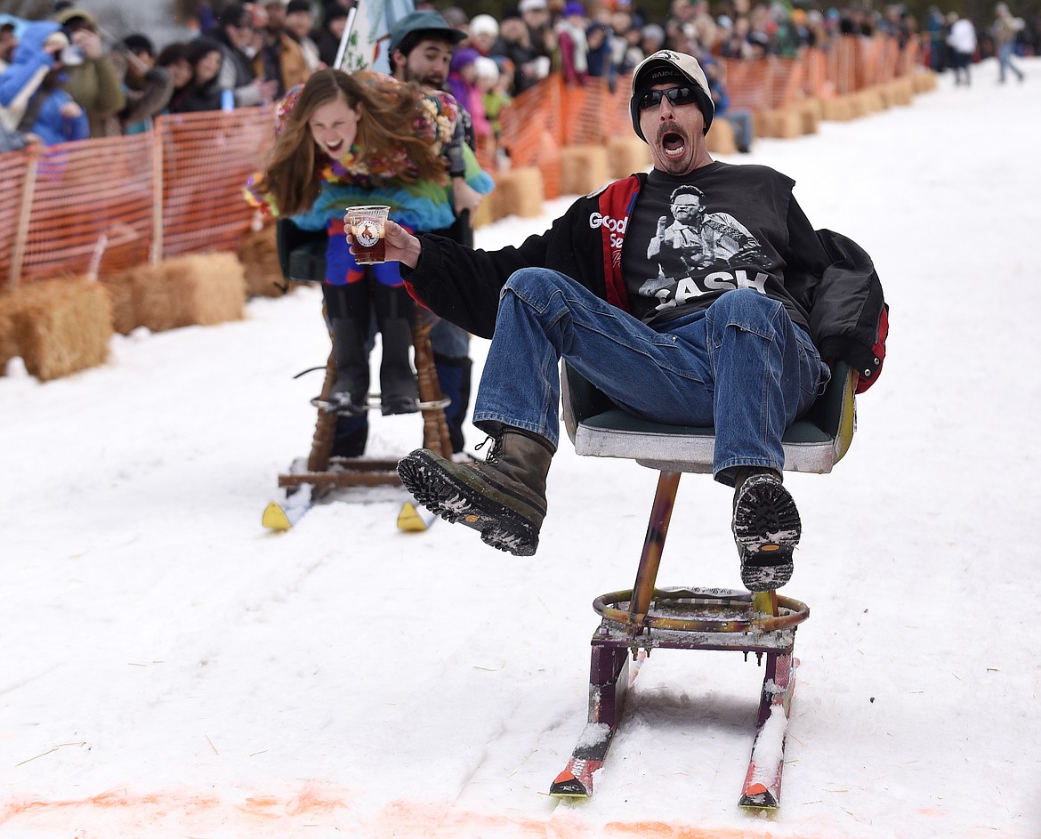 Gary Wallette yells as he crosses the finish line ahead of Jamie Dawson and Tyler McRae during the Cabin Fever Days Barstool Races in Martin City. (Aaric Bryan/Daily Inter Lake file photo)