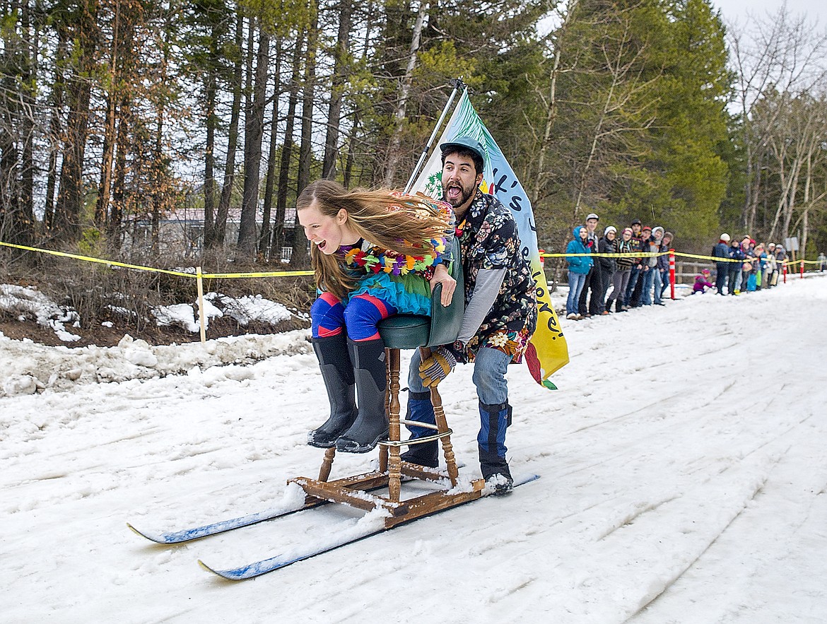 Jamie Dawson and Tyler McRae fly down Sugar Hill during the annual bar stool sled races during Cabin Fever Days in Martin City Saturday.