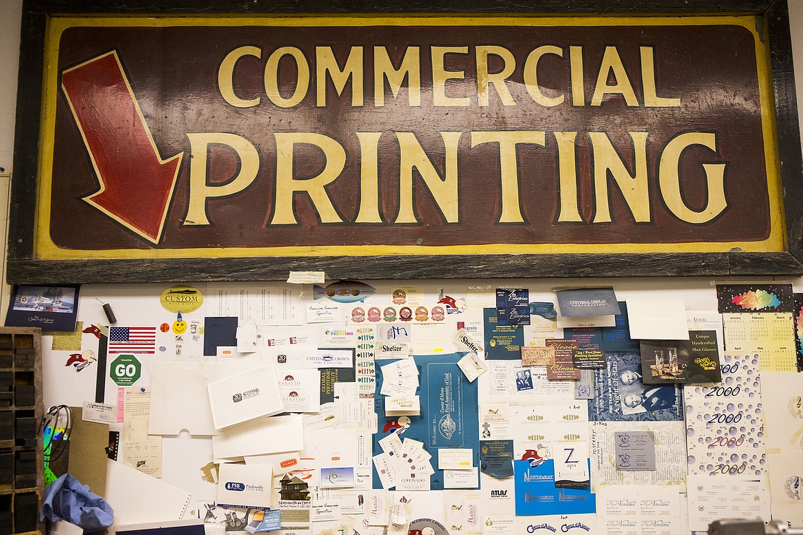 An old Commercial Printing sign hangs on the wall above other printing examples. (LOREN BENOIT/Press)