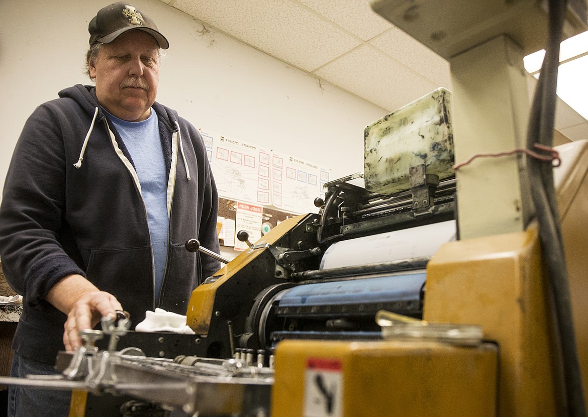 Jim Shehan prints envelopes for the Kroc Center. Shehan has worked for Commercial Printing for 28 years. Several Commercial employees will also be moving a few blocks over to Allegra. (LOREN BENOIT/Press)
