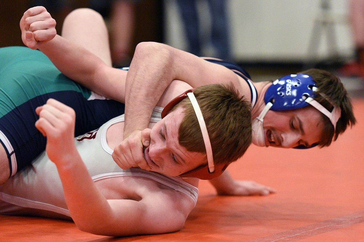 Glacier&#146;s Andrew Glynn works toward a pin of Helena&#146;s Spencer Randall at 152 pounds at the Western AA Divisional seeding tournament at Flathead High School on Saturday. (Casey Kreider/Daily Inter Lake)