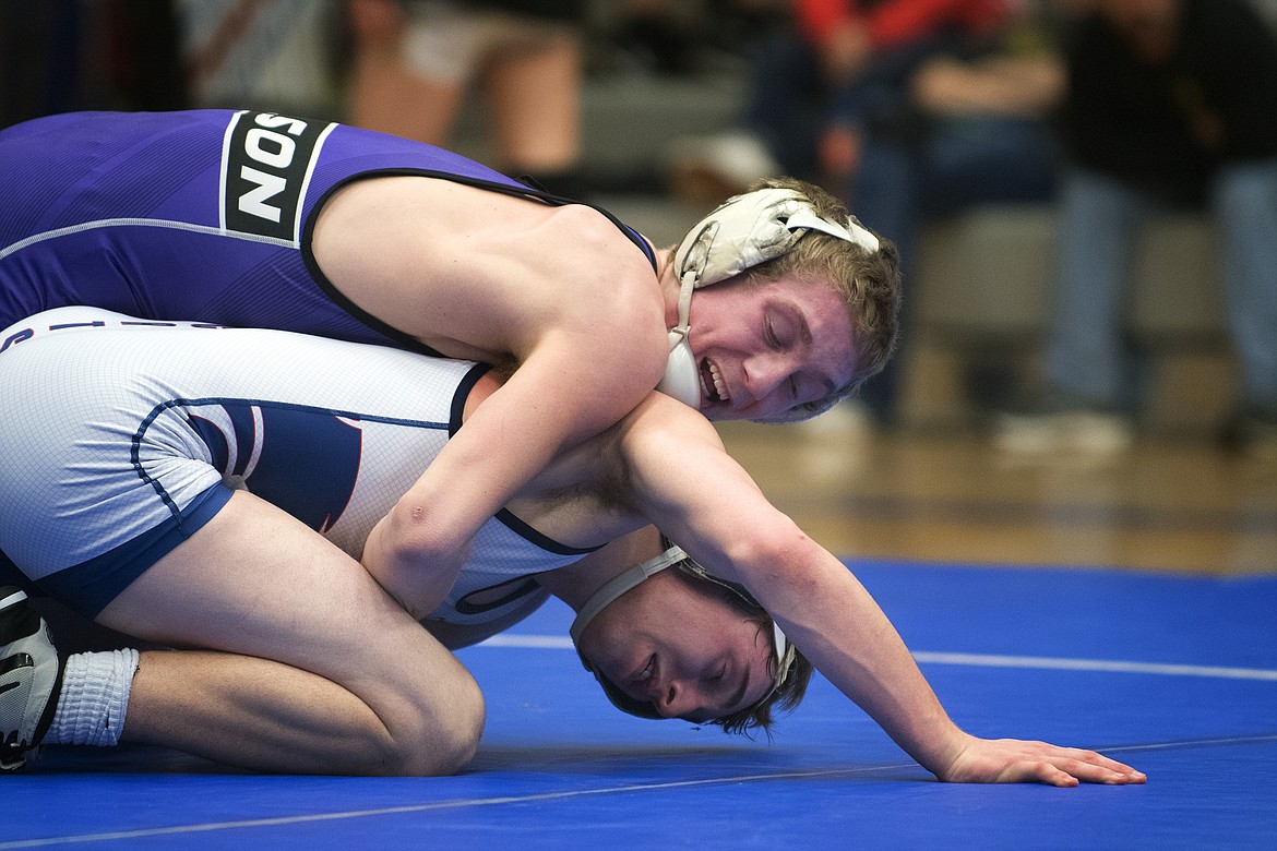 Polson&#146;s Bridger Wenzer takes down Columbia Falls wrestler Brandon Thomas during the 132-pound title match at the Class A Divisional Meet in Columbia Falls Saturday. (Jeremy Weber photo)