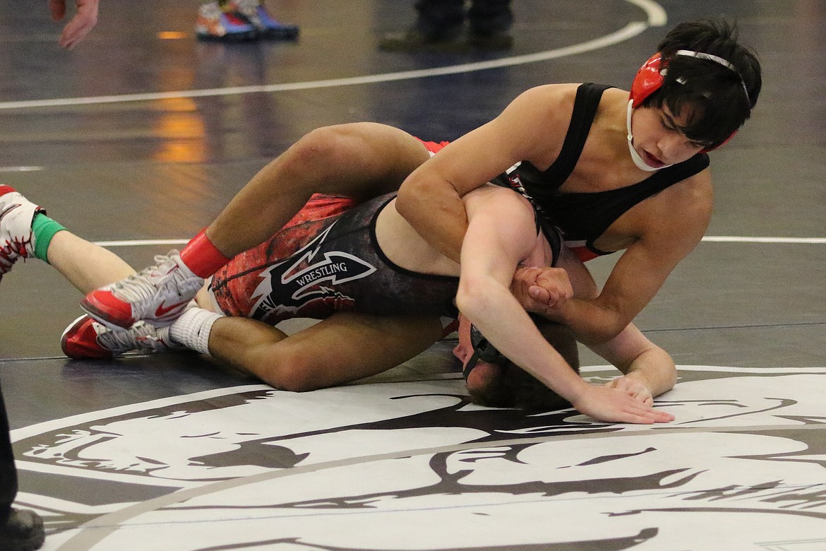 Bob Kirkpatrick/The Sun Tribune
The Huskies' Jaxon Rocha wraps up East Valley&#146;s Stephen Nugent in semifinal action at the District 5/6 Wrestling Championships in Ellensburg Saturday. Rocha dropped the match 10-3, and went on to place fifth with a 5-1 decision over Grandview&#146;s David Saunders.