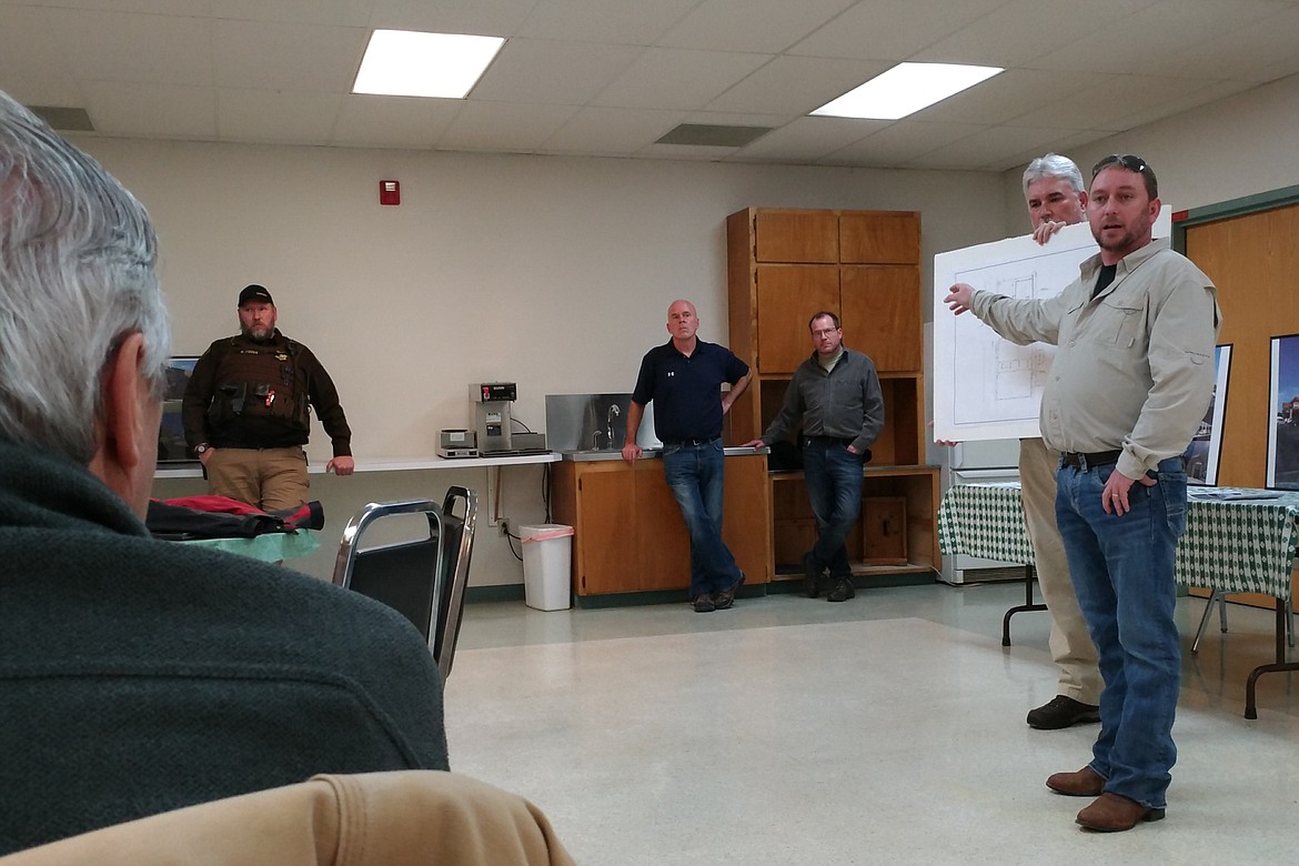 Troy Mayor Dallas Carr holds up a poster with the proposed site plan for the new Town Pump station in Troy as Town Pump project manager Dan Sampson speaks to the members of the community about the company&#146;s plans on Feb. 7. (Ben Kibbey/The Western News)