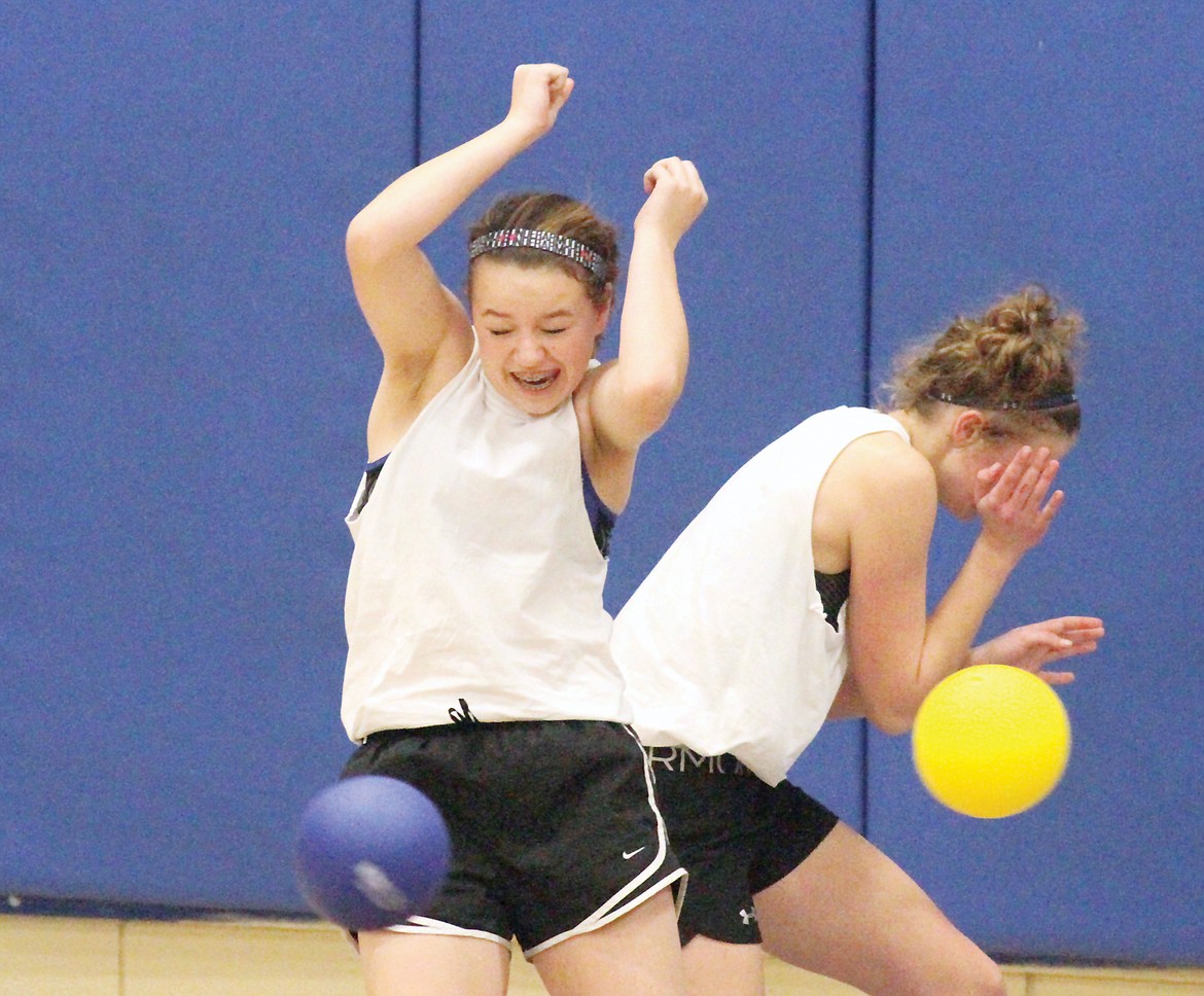 Rachel Carlisle, left, and Elise Erickson play fifth-quarter dodge ball at Libby High School Saturday. (Paul Sievers/The Western News)