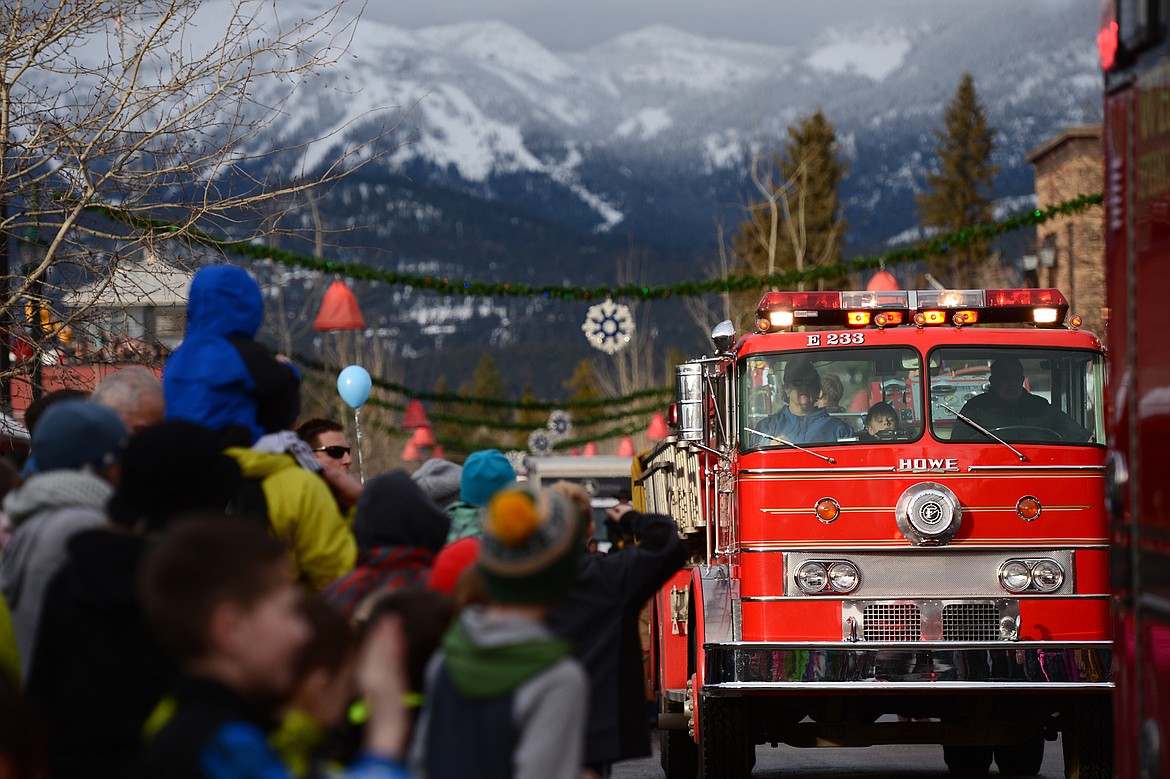 Fire engines make their way down Central Avenue during the Whitefish Winter Carnival Grand Parade on Saturday.