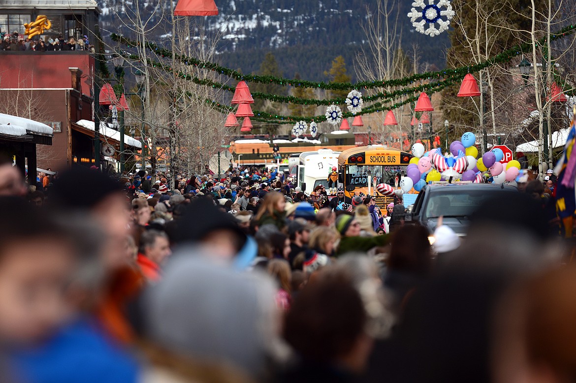 Spectators crowd the sidewalks as floats head down Central Avenue during the Whitefish Winter Carnival Grand Parade on Saturday. (Casey Kreider/Daily Inter Lake)