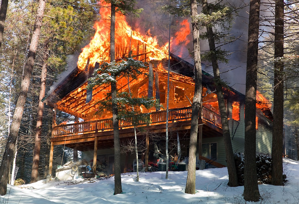 A house on Mooring View Lane is fully engulfed by flames Friday afternoon. (Chris Peterson photo)