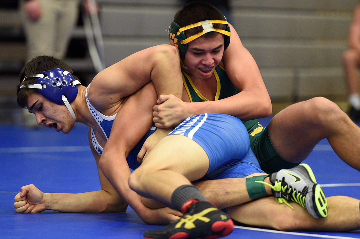 Whitefish&#146;s Robert Bertelsen works toward a pin of Columbia Falls&#146; Isaac Balla at 152 pounds at the Western A Divisional seeding tournament at Columbia Falls High School on Friday. (Casey Kreider/Daily Inter Lake)