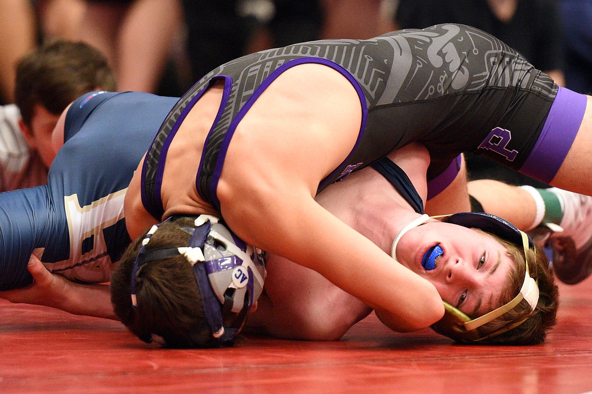 Polson&#146;s Mateo Quinones works toward a pin of Dillon&#146;s Forrest Wagoner at 120 pounds at the Western A Divisional seeding tournament at Columbia Falls High School on Friday. (Casey Kreider/Daily Inter Lake)