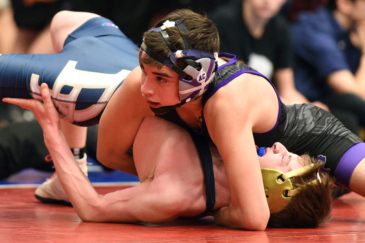 Polson&#146;s Mateo Quinones works toward a pin of Dillon&#146;s Forrest Wagoner at 120 pounds at the Western A Divisional seeding tournament at Columbia Falls High School on Friday. (Casey Kreider/Daily Inter Lake)