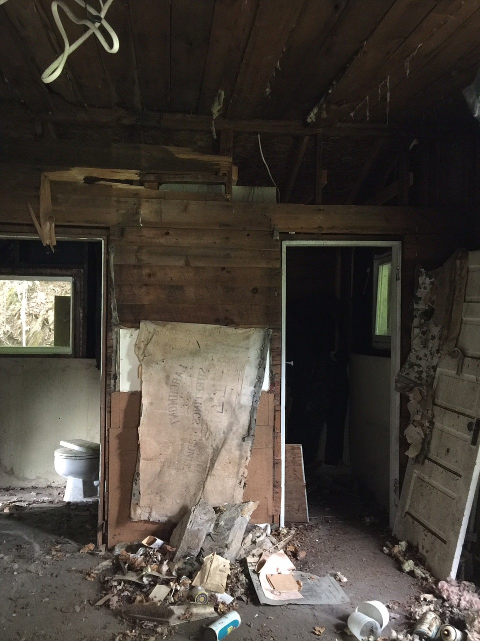 The west side of the home&#146;s interior shows a significant amount of damage and neglect. The rest of the small home shows a similar scene.