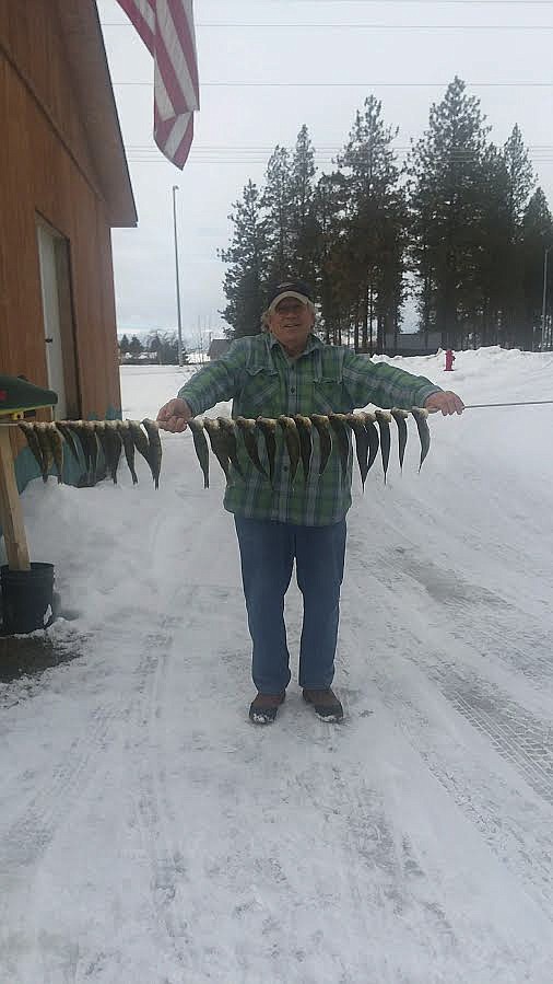 RICHARD &#147;THE MACMAN&#148; Zimmer stands with a string of 25 perch caught last week, where he showed reporter Ashley Fox how to ice fish on Flathead Lake. Together, they caught 25 perch. (Photo courtesy of Zimmer Tackle)