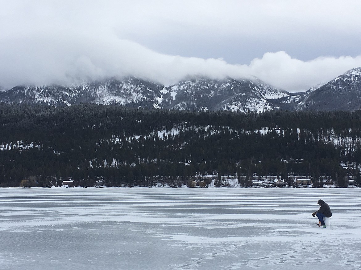 RICHARD ZIMMER, also known as The Macman, ice fishes on Flathead Lake. Here, he is checking one one of several fishing sites. (Ashley Fox/Lake County Leader)