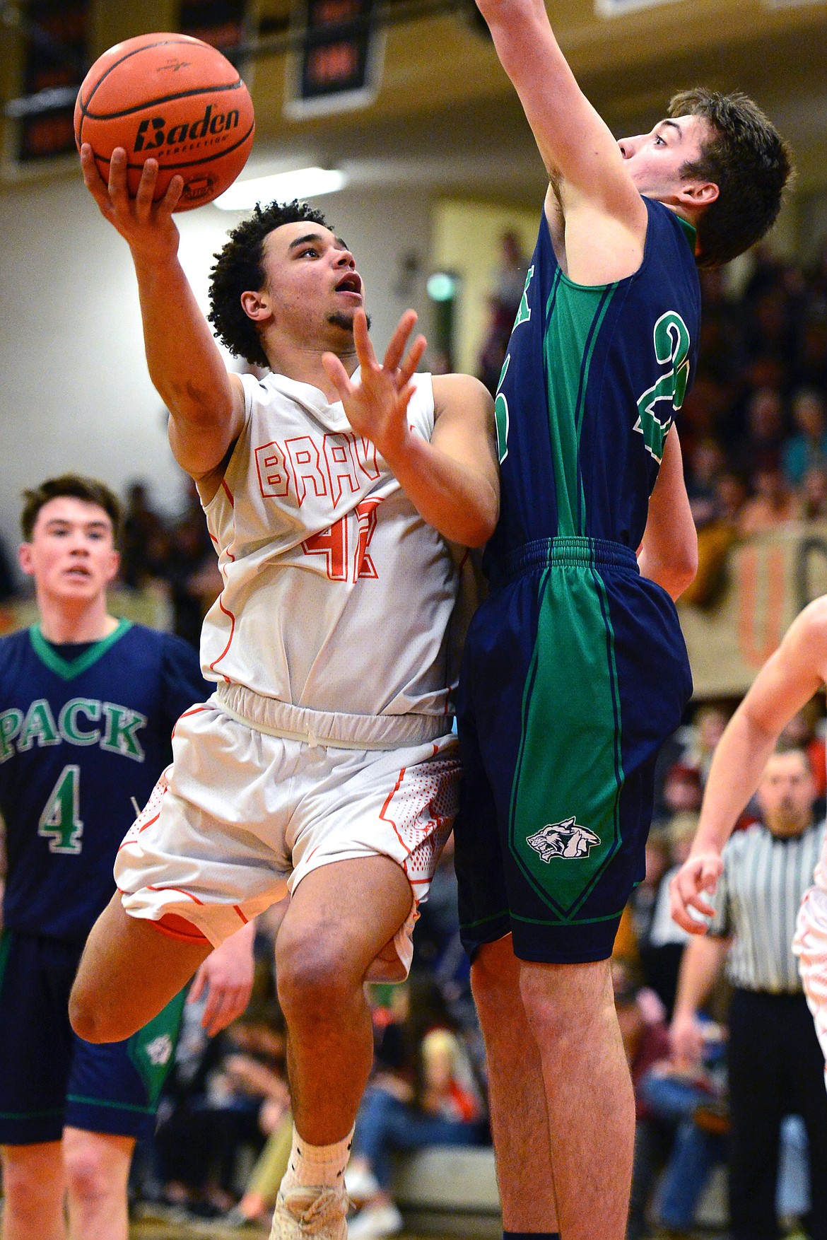 Flathead&#146;s Anthony Jones drives to the hoop against Glacier&#146;s Nick Whitman. (Casey Kreider/Daily Inter Lake)