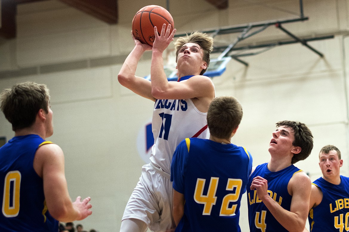 Tucker Salmonsen goes up for two of his team-high 12 points against Libby Thursday. (Jeremy Weber photo)