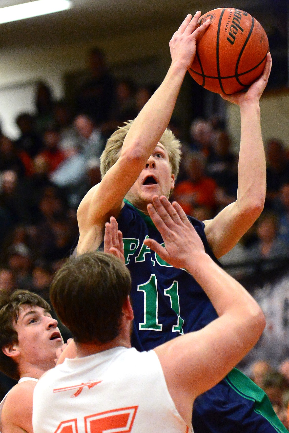 Glacier&#146;s Brec Rademacher drives to the hoop against Flathead defenders Eric Seaman, left, and Dawson Smith. (Casey Kreider/Daily Inter Lake)