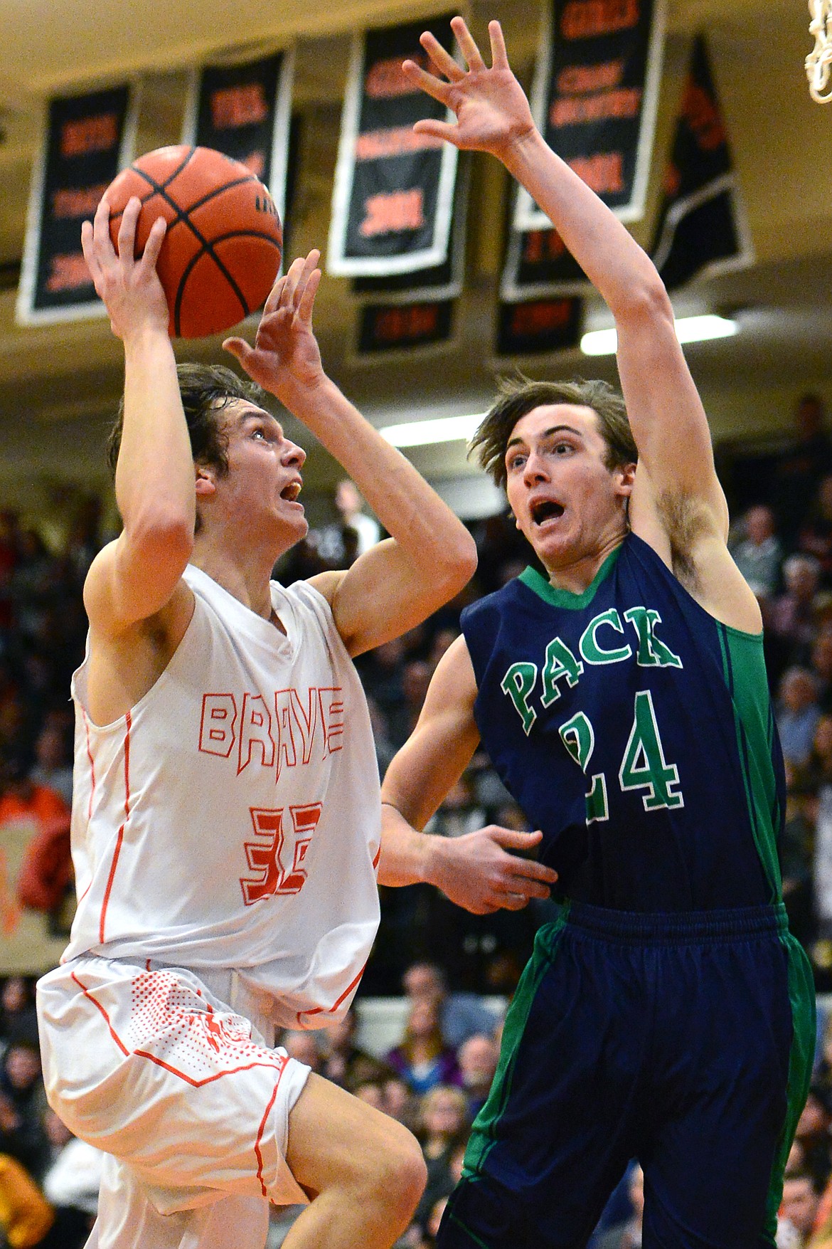 Flathead&#146;s Tyler Johnson drives to the hoop against Glacier&#146;s Alex Whitman. (Casey Kreider/Daily Inter Lake)