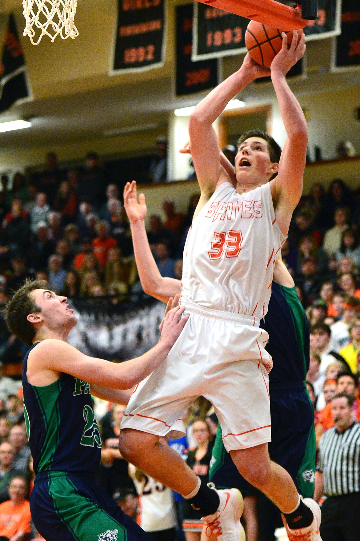 Flathead&#146;s Sam Elliot catches an alley-oop for a layup over Glacier defenders Nick Whitman, left, and Drew Engellant, back. (Casey Kreider/Daily Inter Lake)