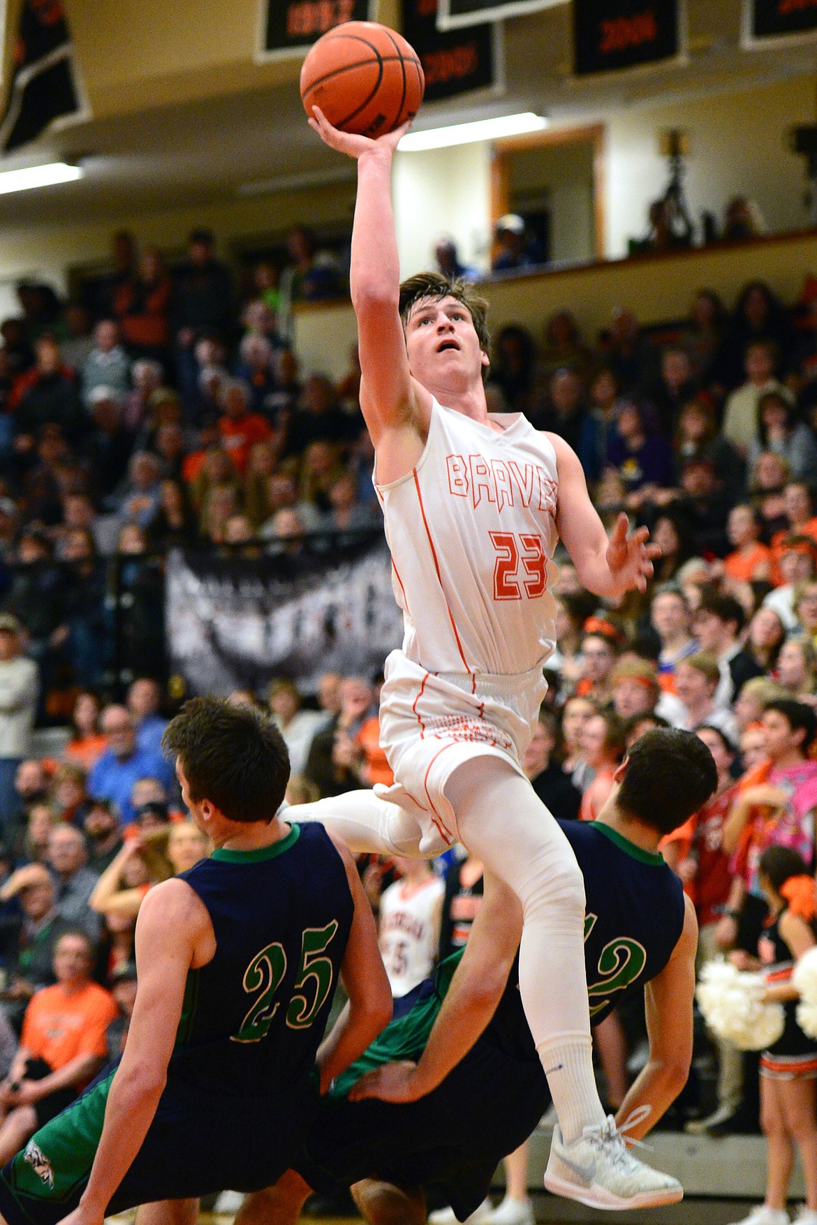 Flathead&#146;s Eric Seaman splits Glacier defenders Nick Whitman (25) and Kody Jarvis (12) on his way to the hoop. (Casey Kreider/Daily Inter Lake)