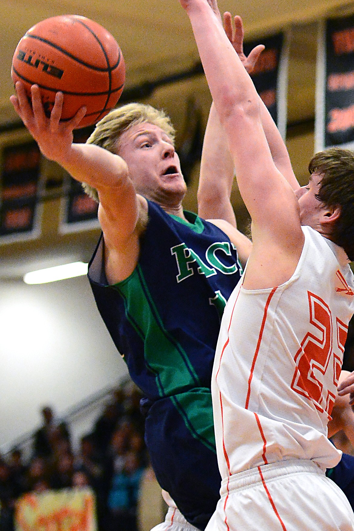 Glacier&#146;s Brec Rademacher drives to the hoop against Flathead&#146;s Eric Seaman. (Casey Kreider/Daily Inter Lake)