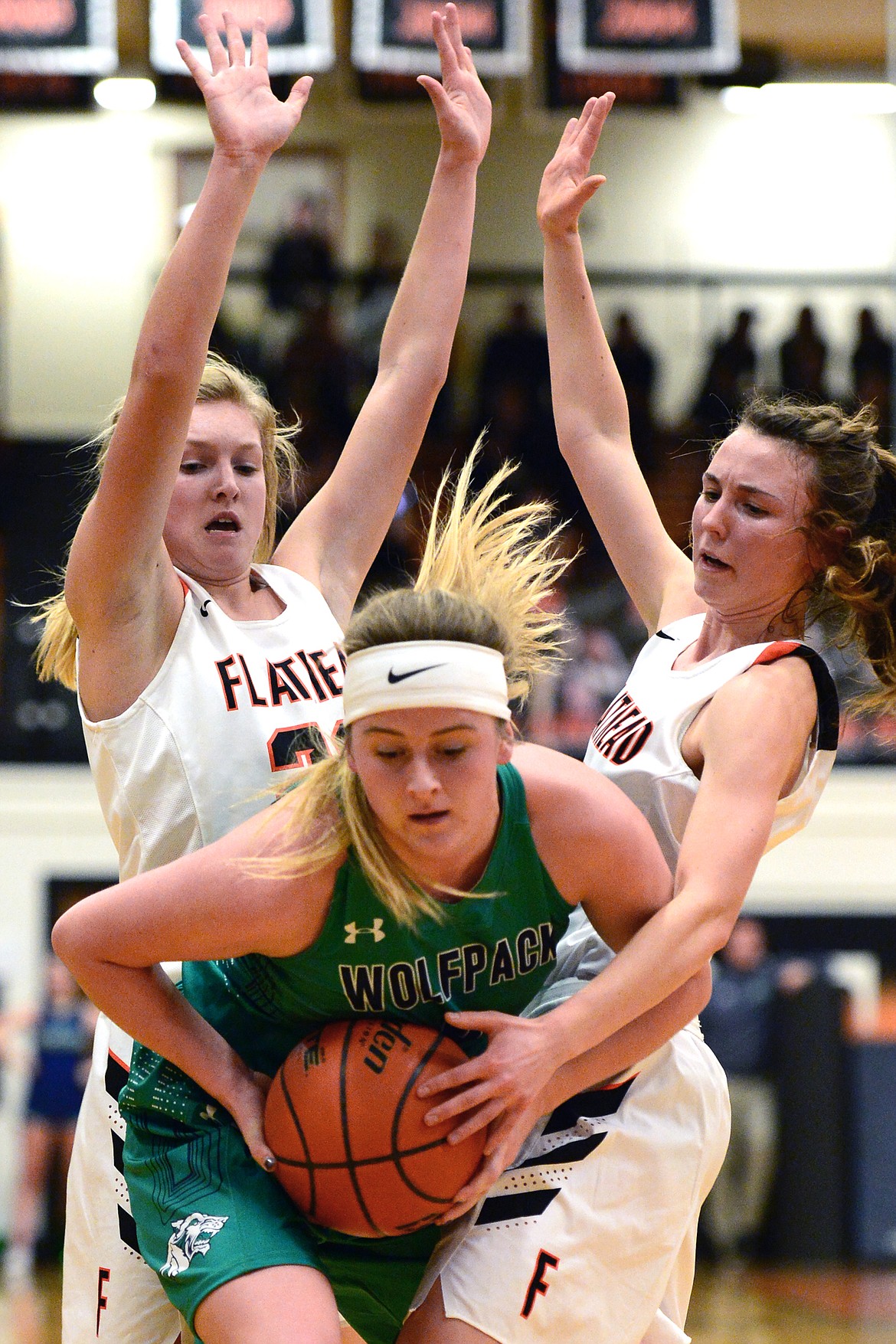 Glacier&#146;s Ellie Stevens is surrounded by Flathead defenders Clara Vandenbosch, left, and Sadie Wilson in the first half at Flathead High School on Thursday. (Casey Kreider/Daily Inter Lake)