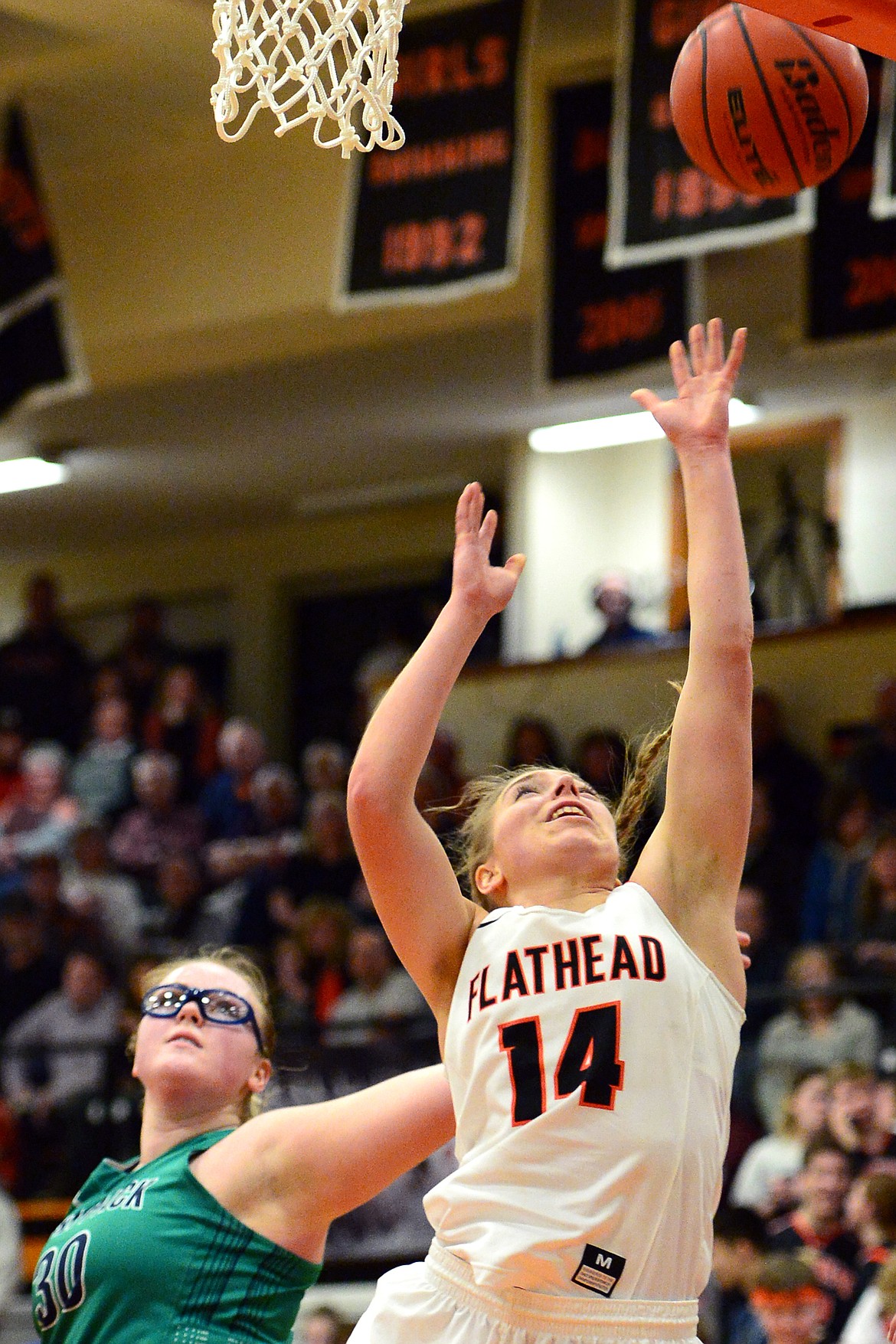 Flathead&#146;s Mary Heaton is fouled on her way to the hoop by Glacier&#146;s Alivia Atlee. (Casey Kreider/Daily Inter Lake)