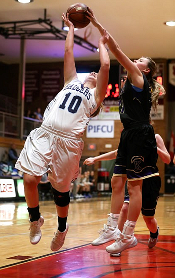 Kellogg's Cierra Brandt swats a Badger shot out of bounds.