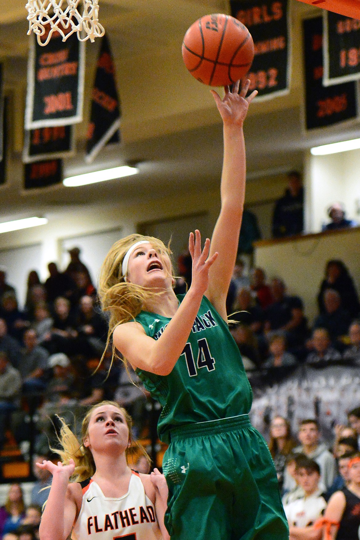 Glacier&#146;s Aubrie Rademacher drives to the hoop for a layup in front of Flathead defender Maddie Walter at Flathead High School on Thursday. (Casey Kreider/Daily Inter Lake)