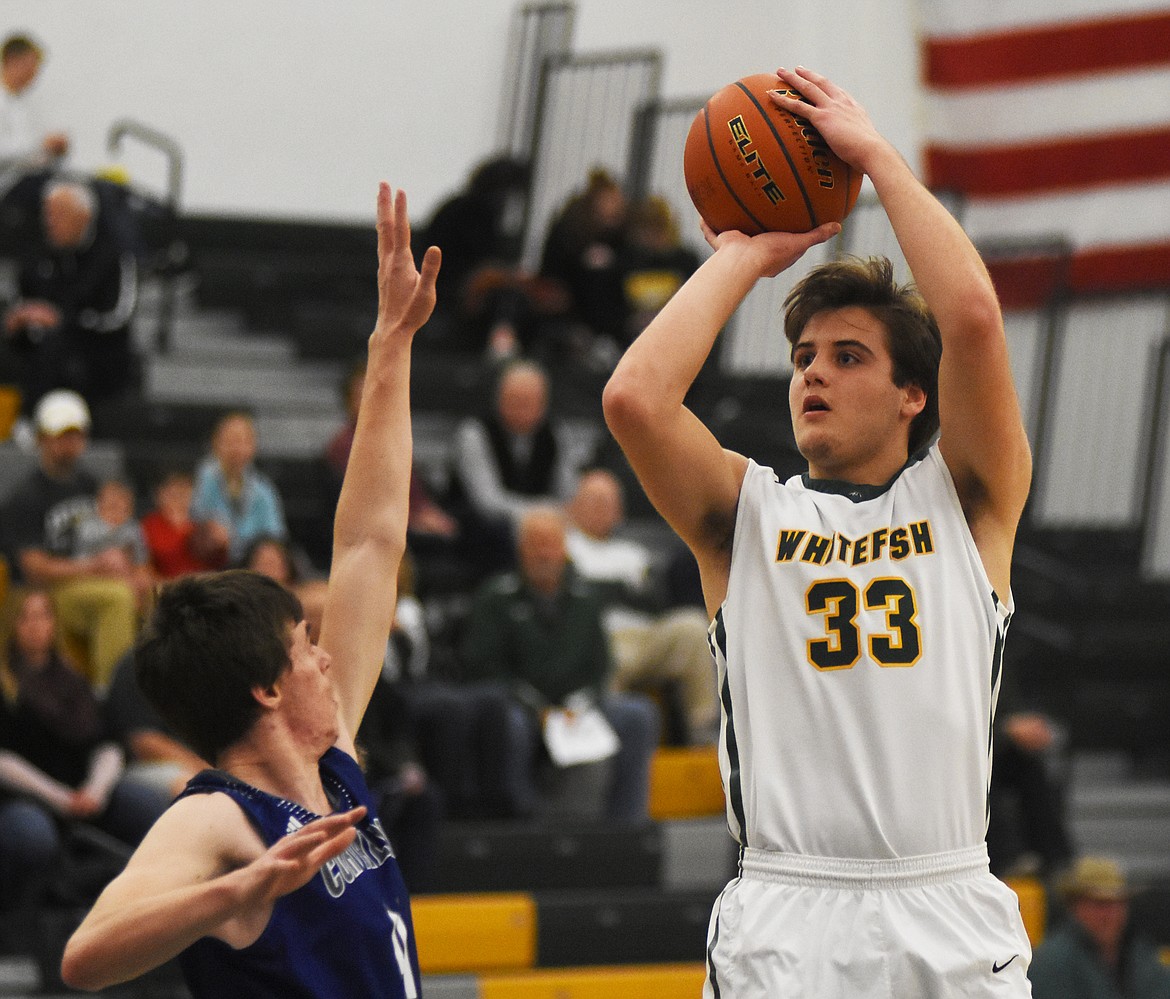 Ryan Kemm pulls up for the jumper against Corvallis on Friday at Whitefish High School. (Daniel McKay/Whitefish Pilot)